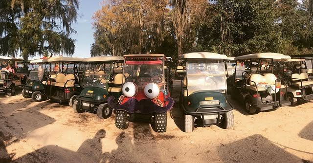 Zerble parked in a row of plain green rental golf carts at Fort Wilderness, the only one with eyes and a mustache.