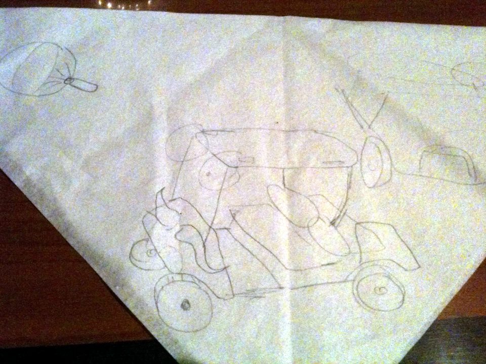The original 2011 pencil sketch of Zerble on a folded paper napkin: a golf cart with eyes on stalks and a curly mustache.